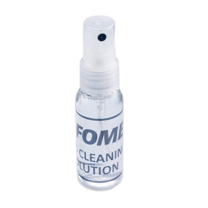 Fomei lens cleaning kit featuring microfiber cloth, cleaning solution, and brush for camera lens maintenance.