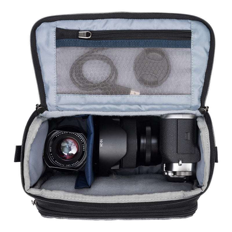 Cool grey ThinkTank Mirrorless Mover 20 v2 camera bag with adjustable shoulder strap and padded compartments.
